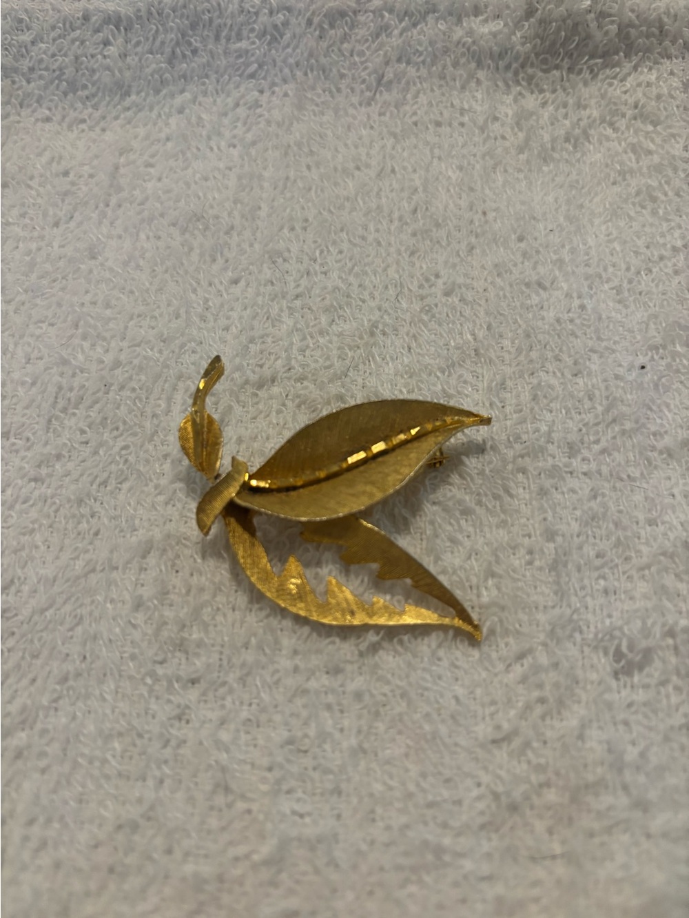 Gold tone double leaf brooch
